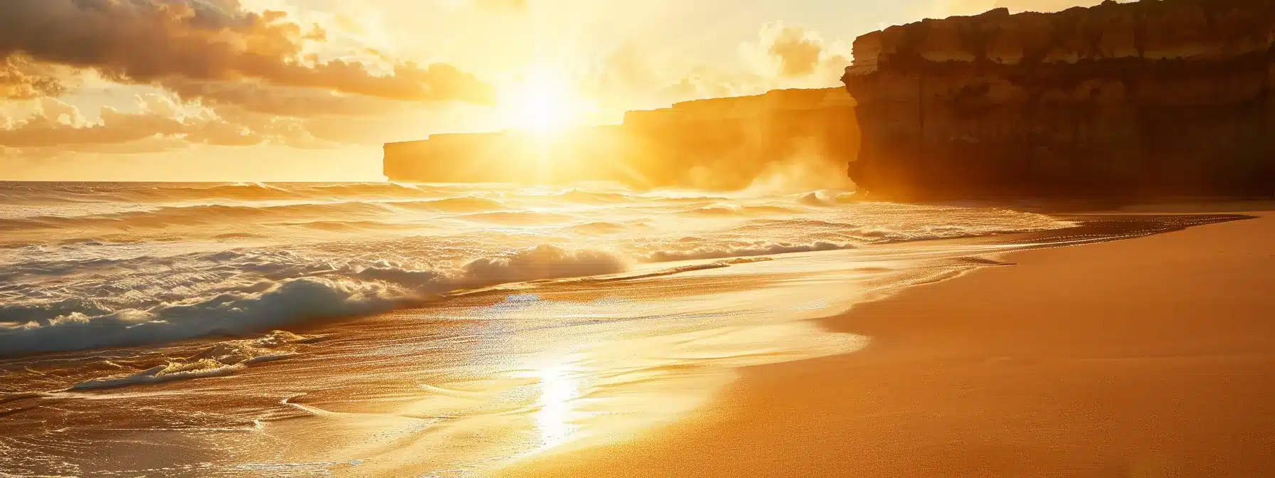 a radiant sunrise bathes a serene coastal landscape in warm golden hues, highlighting the gentle waves lapping against pristine white sands and a distant silhouette of rugged cliffs.